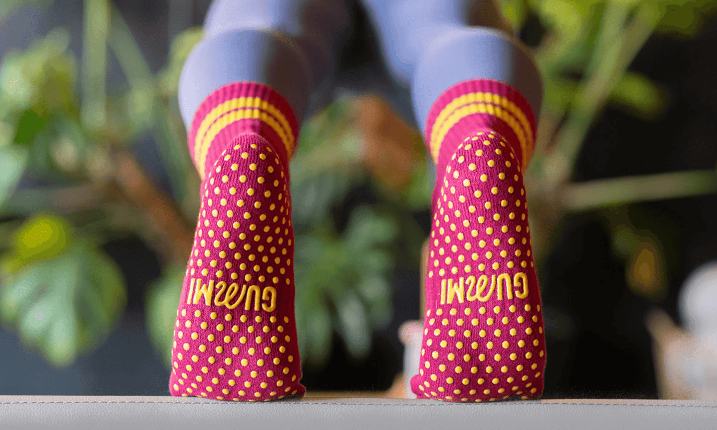 The soles of red and yellow GUMMI socks.