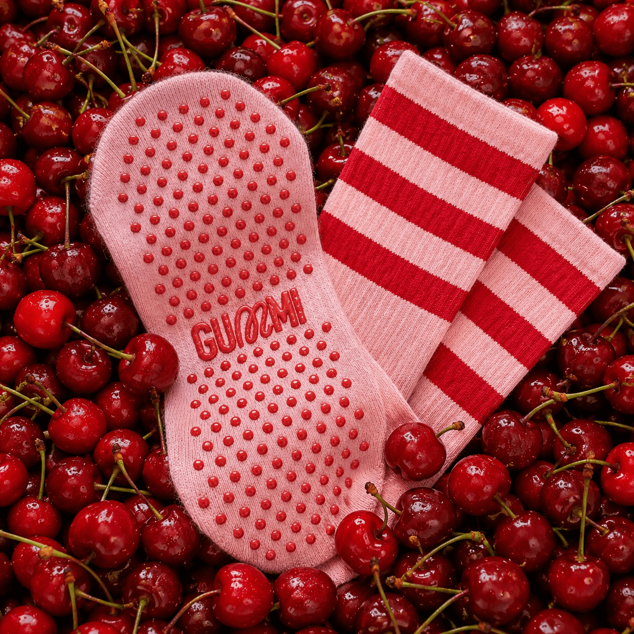 Pink Cherry Pop pilates socks in a pile of cherries