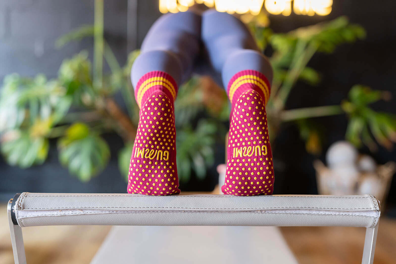 The bottoms of GUMMI grip socks on a pilates bed bar.