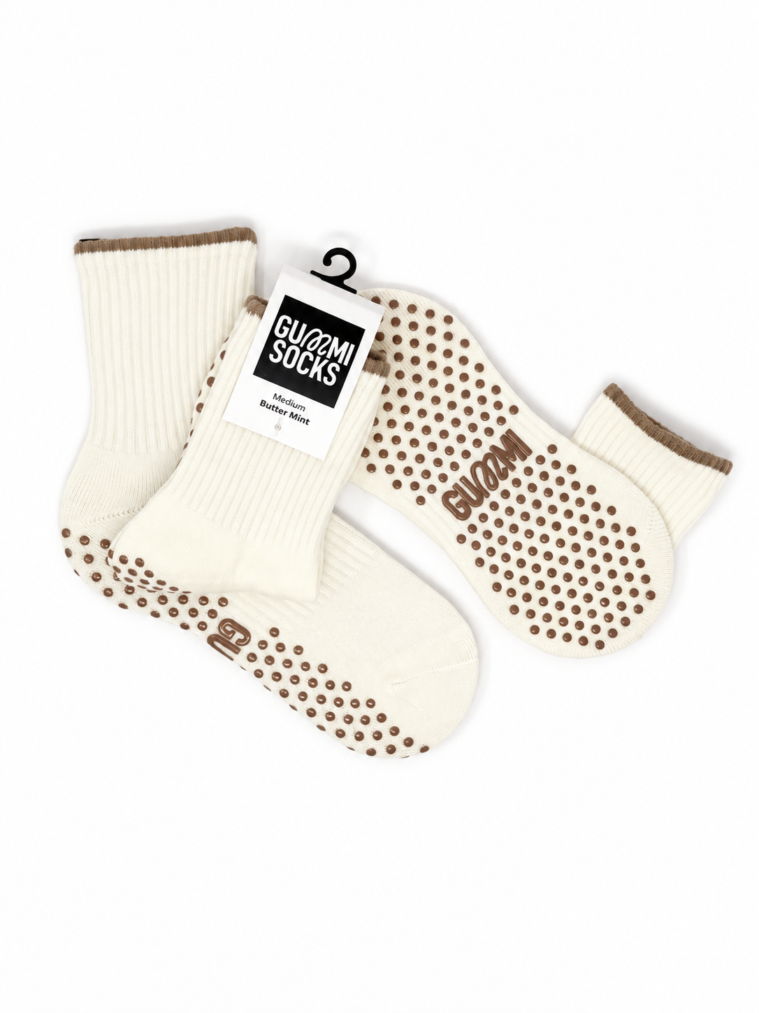 GUMMI Butter Mint cream Pilates grip socks flat lay showing brown non-slip soles, knitted crew socks and product packaging
