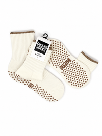 GUMMI Butter Mint cream Pilates grip socks flat lay showing brown non-slip soles, knitted crew socks and product packaging