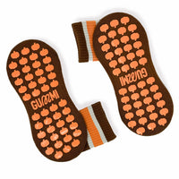 Brown Halloween Pilates grip socks with orange and cream striped cuff