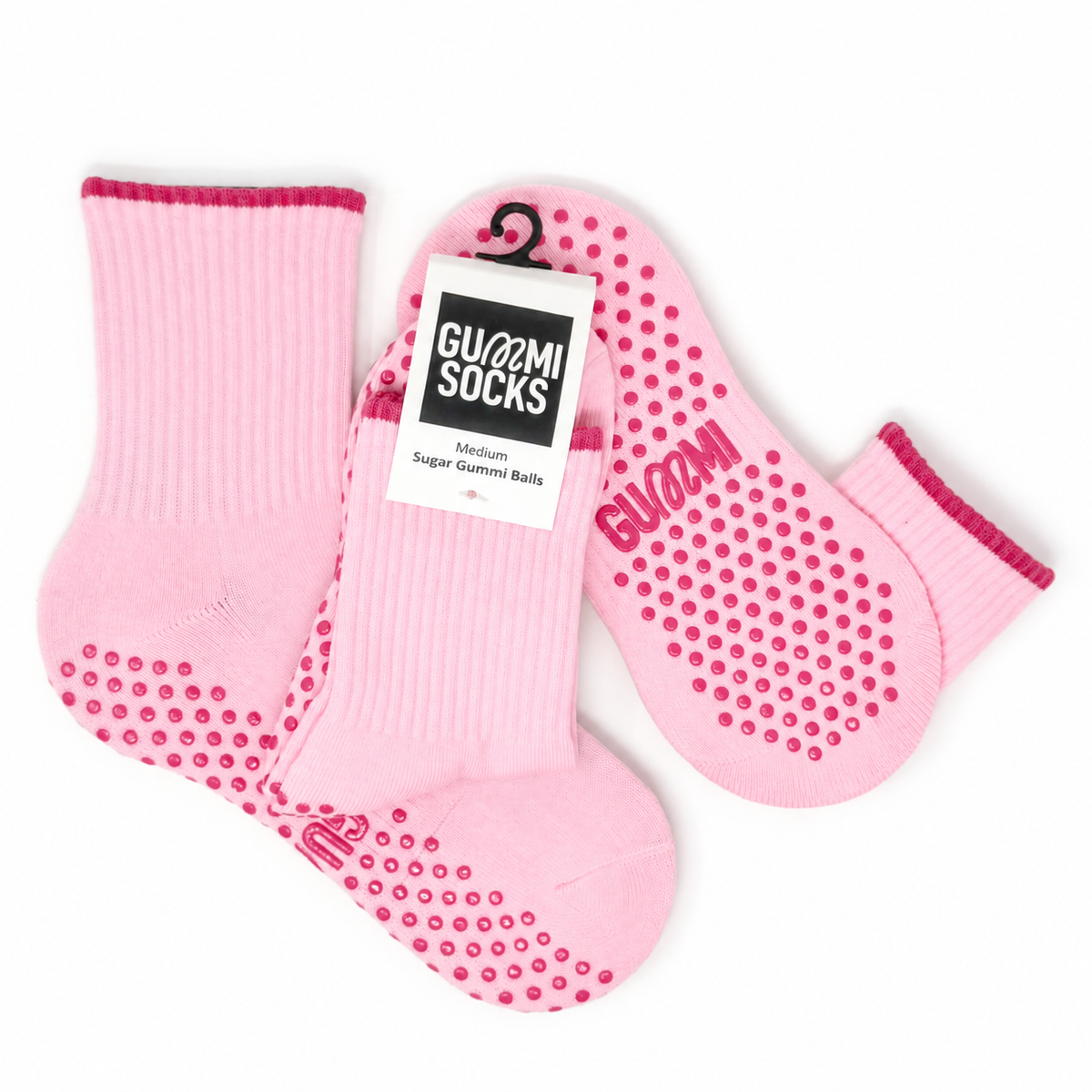 GUMMI Sugar Gummi Balls pastel pink crew Pilates grip socks with raspberry grip detailing, shown in a flat lay