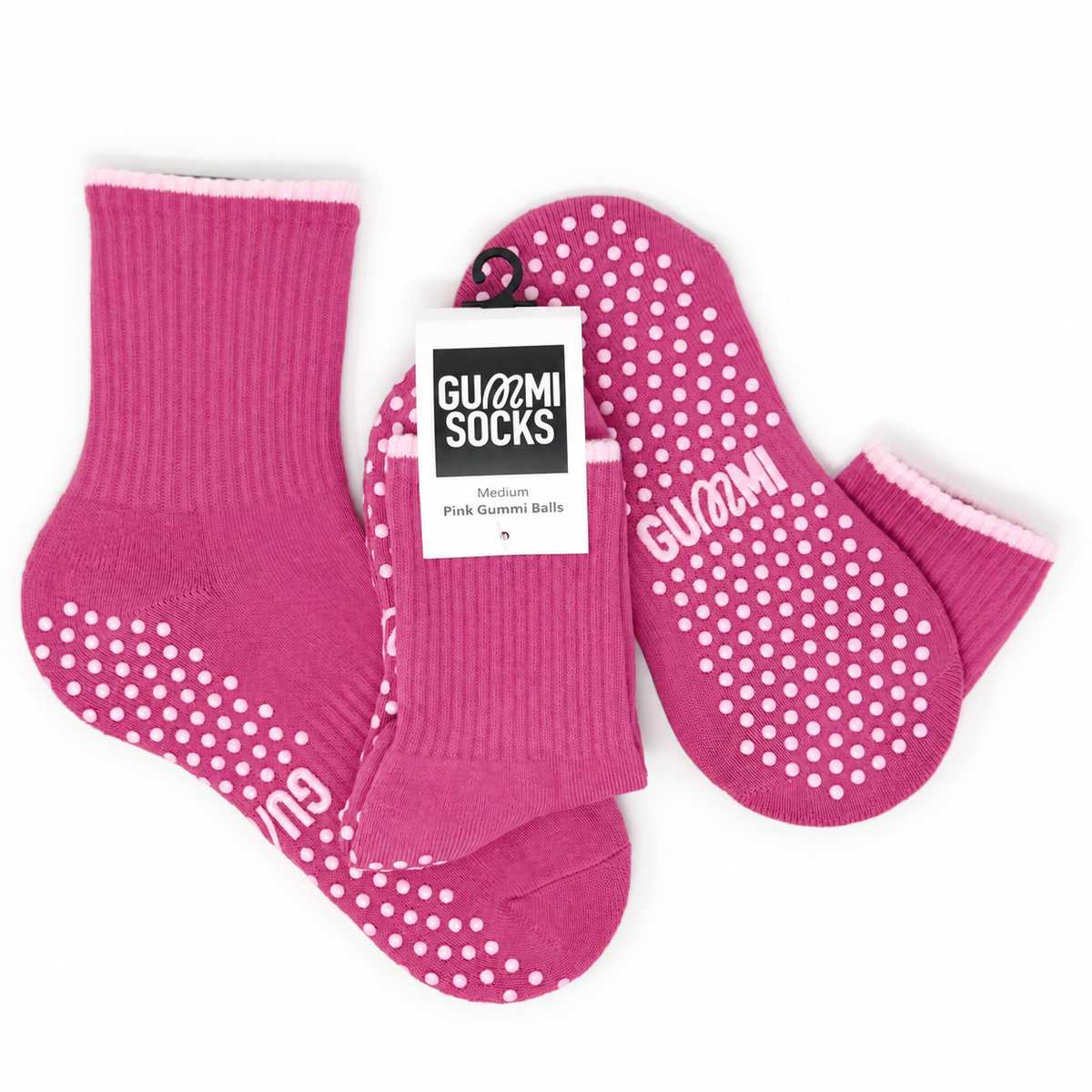 GUMMI Pink Gummi Balls vibrant pink Pilates grip socks shown in a flat lay with matching pink non-slip soles