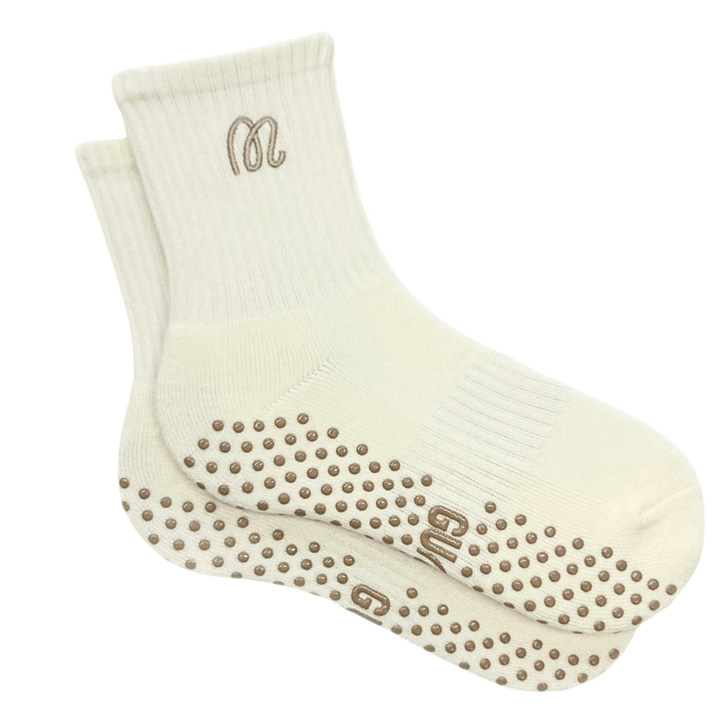 Pair of cream socks with grip dots on a white background