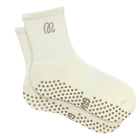Pair of cream socks with grip dots on a white background