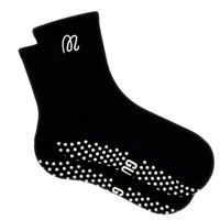 Black grip socks with white grip dots and logo on a white background