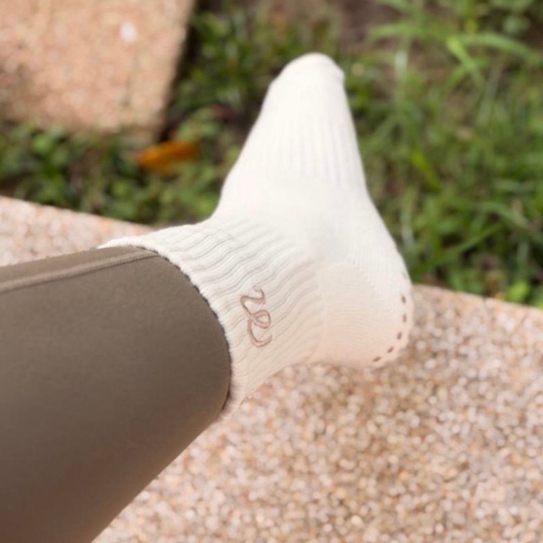 White pilates sock on a blurred natural background